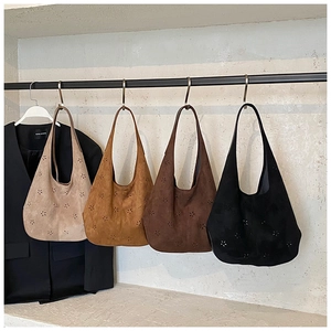 Detailed laser-cut floral patterns on suede tote bags in four neutral colors
