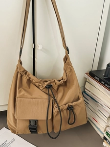 Japanese style brown drawstring bucket bag with multiple pockets for daily commuting