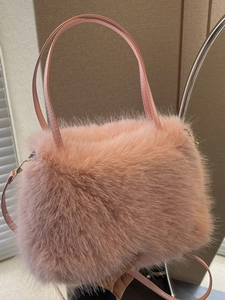Stylish pink faux fur plush tote bag for women with leather handles and gold metal strap