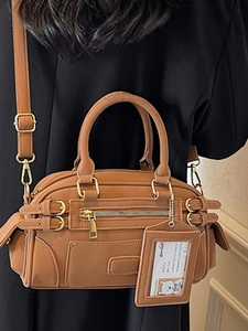 Brown leather boston underarm bag with adjustable strap and vintage utility style