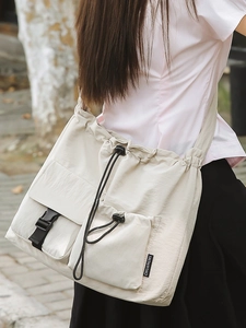 Japanese style cream drawstring bucket bag with adjustable strap for daily casual commuting