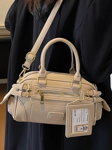 Elegant beige faux leather Boston shoulder bag with adjustable strap and zip details