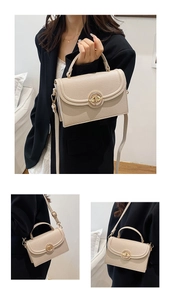 Close-up of cream leather crossbody bag featuring gold round turn-lock and lychee texture