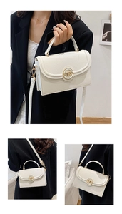 Macro detail of white lychee leather handbag with gold ring metal clasp closure