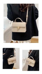 Close-up of beige lychee grain leather handbag with gold ring twist lock and handle
