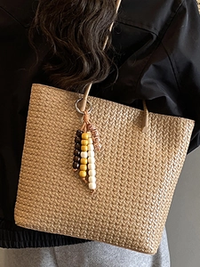 Large vintage woven tote bag in beige brown with wood bead tassels for chic daily commuting