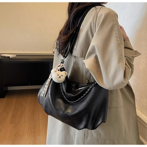 Black large capacity tote bag with silver chain detail and white plush bear charm