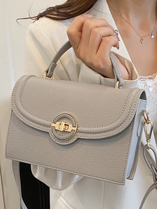 Elegant grey pebbled leather crossbody bag with gold round clasp and handle for women