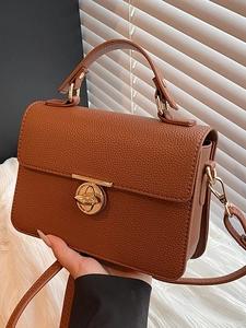 Brown lychee leather square handbag with golden metal lock and top handle for women