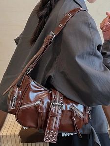 Vintage brown glossy motorcycle shoulder bag with metal zippers and rivet details