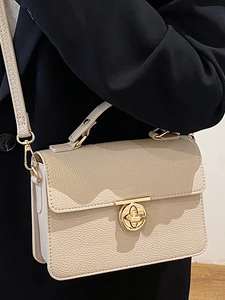 Beige lychee pattern leather handbag with gold twist lock and adjustable shoulder strap