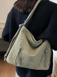 Gray-green large capacity shoulder bag with unique star zipper on black sweater