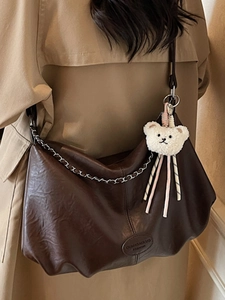 Dark brown leather hobo bag with silver chain and cute teddy charm on shoulder
