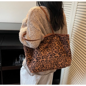Detailed back view of a large leopard print tote bag worn over the shoulder for fall style