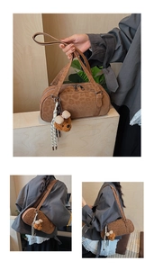 Close-up of brown suede bowling bag featuring leopard pattern and plush bear charm