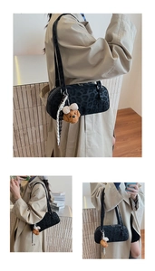 Close-up of leopard print shoulder bag with teddy bear charm and checkered scarf detail
