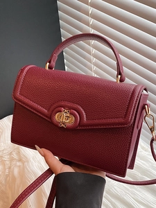 Chic dark red pebble leather handbag with gold turn-lock closure and top handle