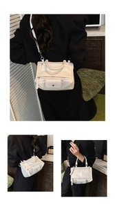 Detail of white lychee pattern faux leather bag with double zippers and front pocket