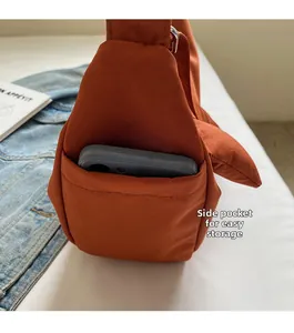 Detail view of the side pocket on this canvas dumpling bag holding a smartphone