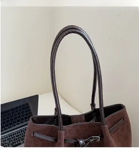 Detail of leopard print tote bag showing suede texture and glossy leather handles