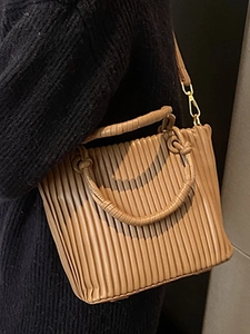 French retro caramel pleated bucket bag with woven handle and adjustable strap
