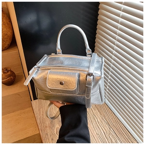 Detail of silver metallic wrinkled texture and magnetic front pocket on handbag