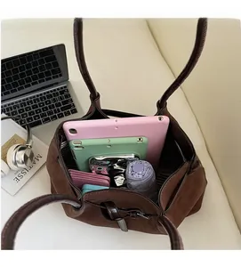 Spacious interior of a vintage dark brown tote bag showing capacity for tablets and umbrella