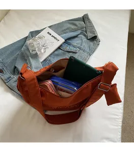 Detail view of spacious orange canvas tote showing large capacity for daily essentials