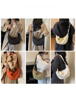 Detail view of canvas crescent bags in five colors with MULAIDI embroidery for daily commute