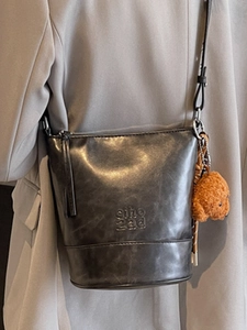 Retro grey leather bucket bag with shoulder strap and plush teddy bear charm