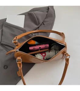 Internal view of caramel leather shoulder bag showing storage capacity for daily essentials