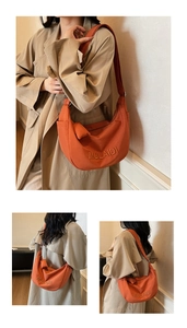 Detail of orange nylon hobo bag with MULAIDI embroidery and adjustable shoulder strap
