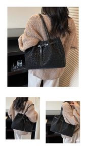 Detail of vintage black leopard embossed tote bag with slim shoulder straps and sleek buckle