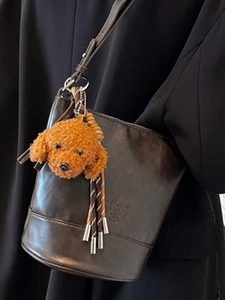 Vintage brown leather bucket bag with cute brown plush dog charm and silver chain