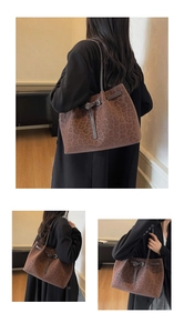 Close-up detail of leopard print tote bag with brown leather strap and metal buckle