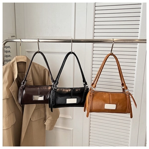 Chic vintage baguette bags in coffee, black, and caramel hanging on a display rack