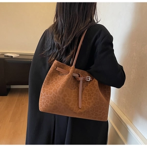 Detail of vintage leopard print tote bag in brown faux suede with metal buckle