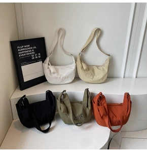 Collection of minimalist crescent canvas crossbody bags in five stylish colors with straps