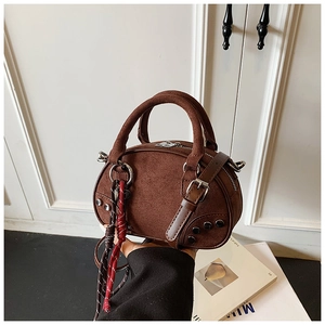 Detail of dark coffee suede shoulder bag with metallic rivets and woven rope decoration