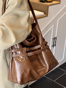 Brown high-gloss tote bag with decorative buckles and wrinkled texture for women