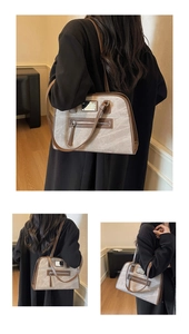 Detailed view of large grey tote bag with vintage texture and stylish tassel zipper detail