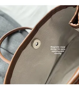 Detail view of the magnetic closure and chevron fabric lining of this bucket bag