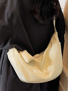 Minimalist beige canvas crescent crossbody bag with MULAIDI embossed lettering