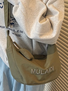 Olive green nylon crescent crossbody bag with white embroidery for daily casual commute