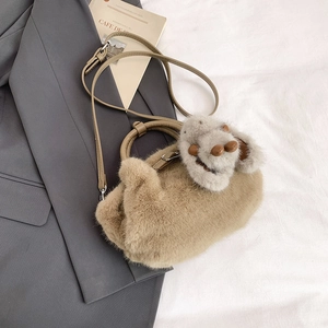 Détail du sac seau en peluche kaki avec bandoulière en cuir et breloque lapin doux