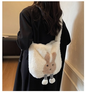 Detail view of white plush bucket bag featuring a cute brown rabbit pattern and striped legs