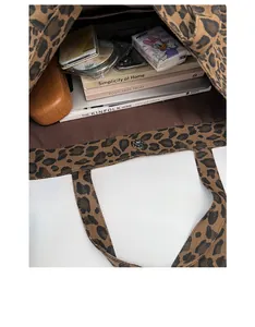 Spacious leopard print canvas tote bag interior showing capacity for tablet and books