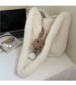 Detail of a large white plush bucket bag with a brown bunny accent on a student desk