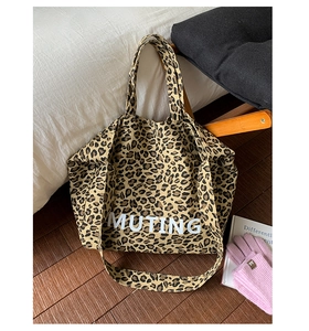 Detail of leopard print canvas tote bag with MUTING logo and wide shoulder straps