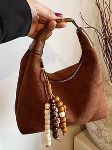 Vintage brown quilted crossbody bag for women featuring stylish wooden bead pendant detail